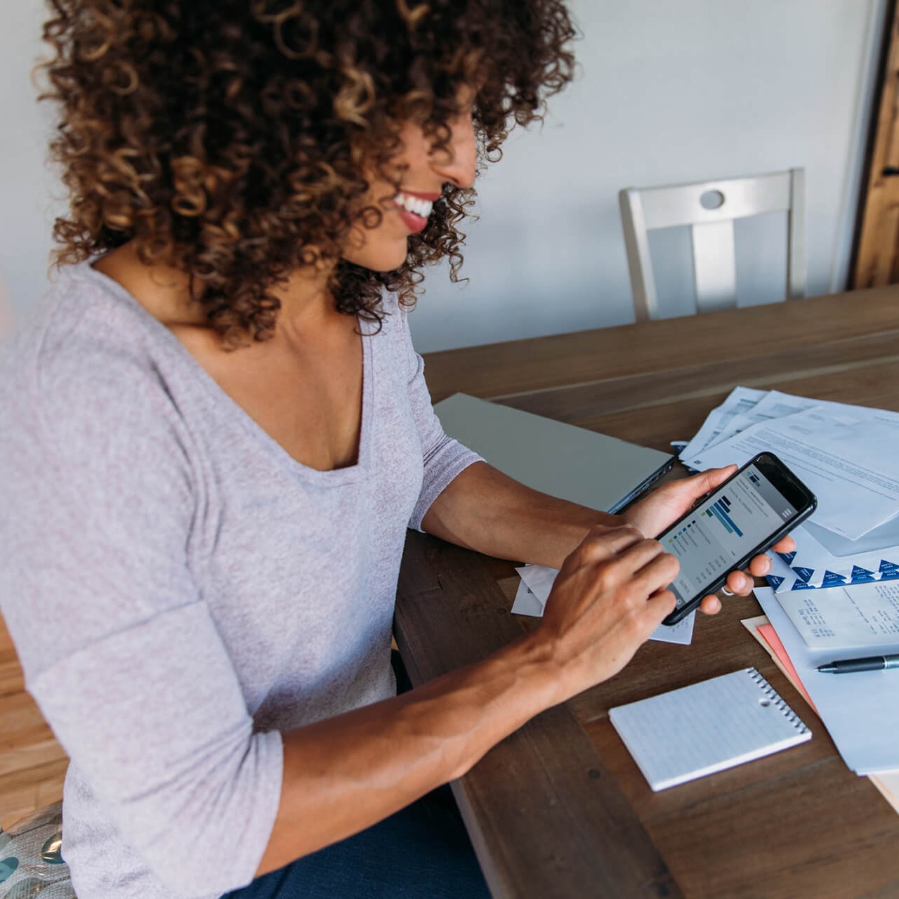 image-woman-doing-finances-at-home-on-smart-phone-1